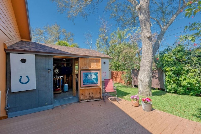 exterior space with a storage shed, a lawn, an outdoor structure, and fence