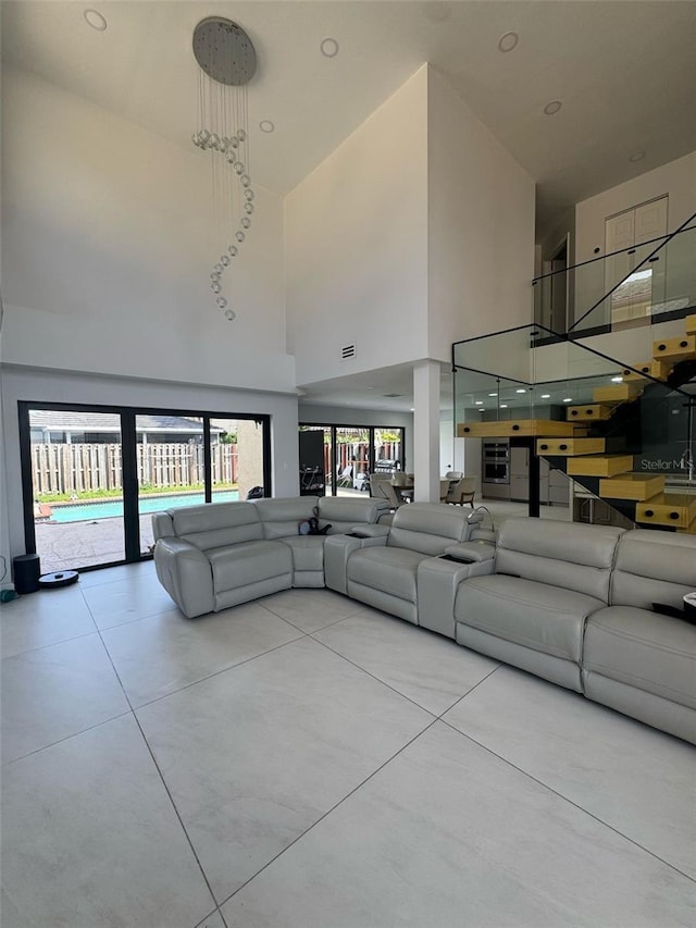 unfurnished living room featuring a high ceiling