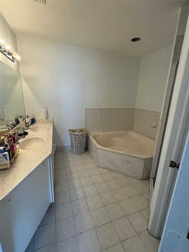 full bath with double vanity, tile patterned flooring, a sink, and a bath