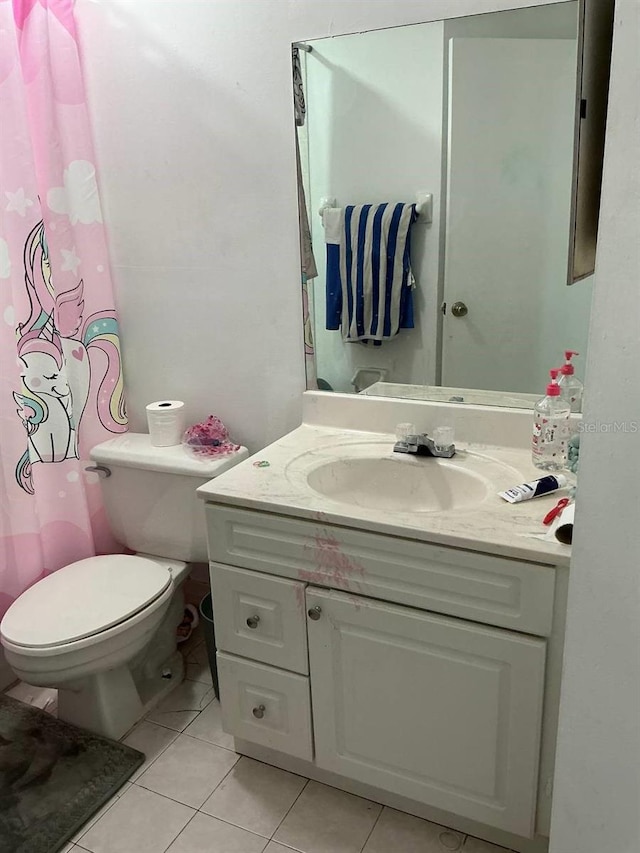 bathroom with vanity, toilet, and tile patterned floors