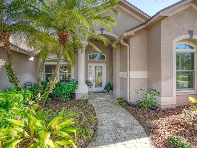 property entrance featuring french doors and stucco siding