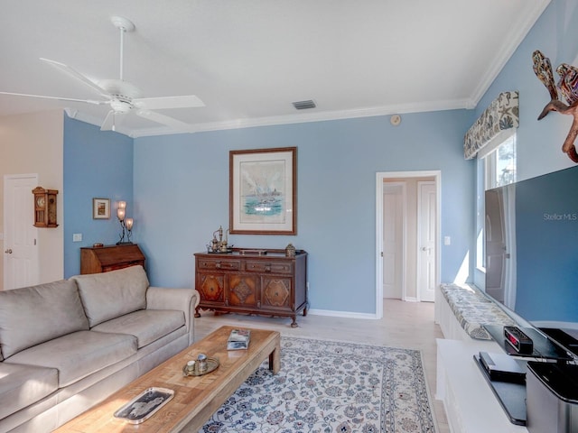 living area featuring light wood finished floors, visible vents, baseboards, a ceiling fan, and ornamental molding