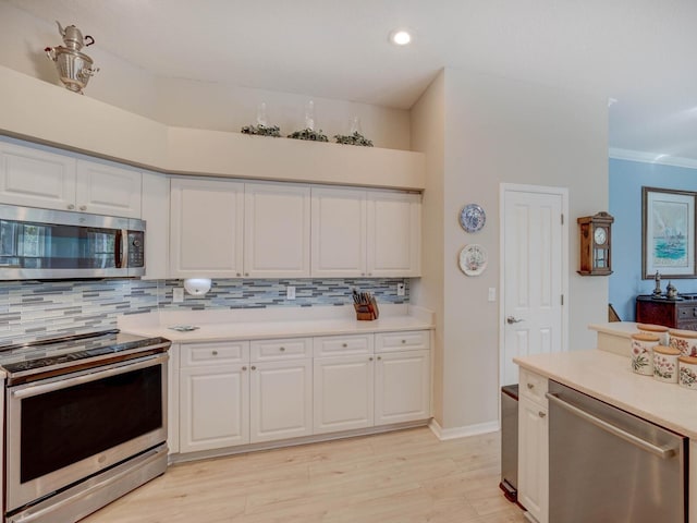 kitchen featuring white cabinetry, appliances with stainless steel finishes, light countertops, and backsplash