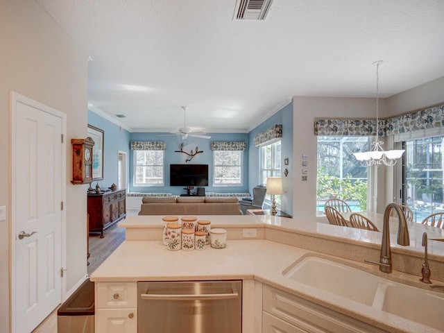 kitchen featuring visible vents, open floor plan, hanging light fixtures, a sink, and stainless steel dishwasher