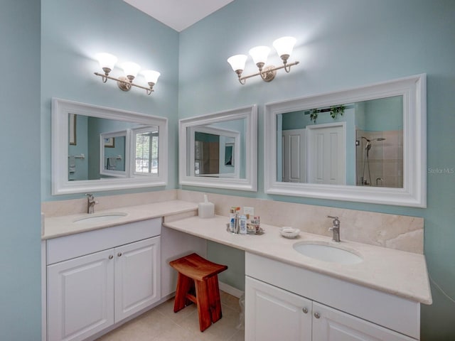 full bathroom featuring a tile shower, tile patterned flooring, and vanity