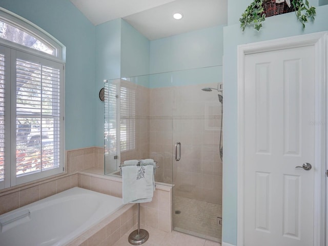 full bathroom with a garden tub and a shower stall