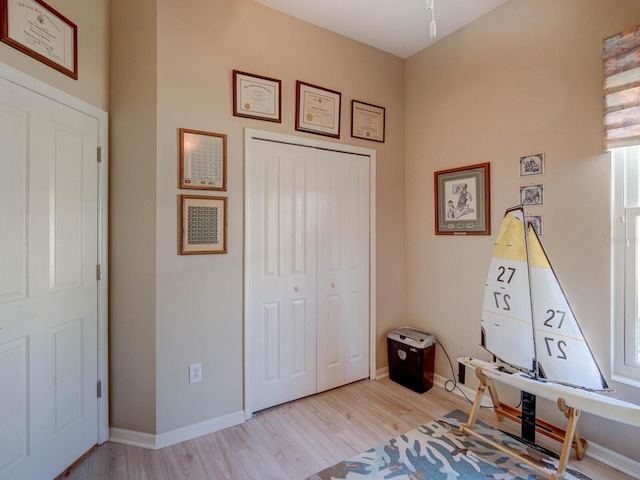 rec room with wood finished floors and baseboards