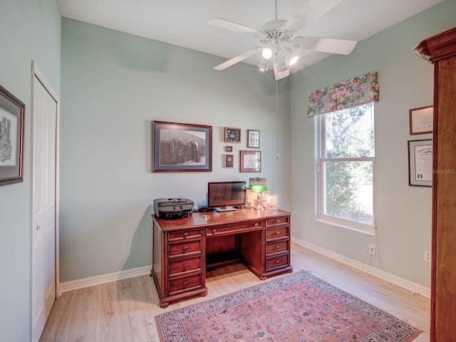 home office with light wood finished floors, ceiling fan, and baseboards