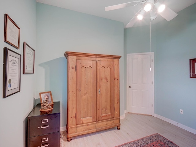 bedroom featuring ceiling fan, light wood-style flooring, and baseboards