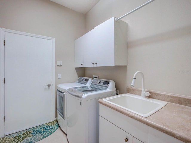 laundry room featuring cabinet space, washer and dryer, and a sink