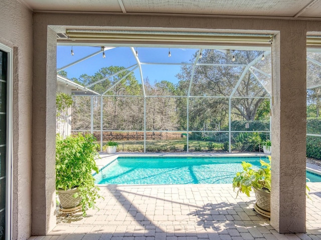 pool with a lanai and a patio area