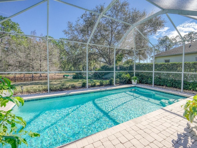 view of pool with glass enclosure, a patio, and a fenced in pool