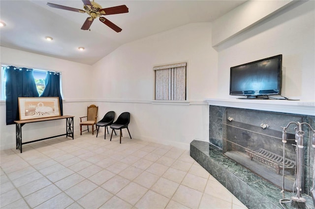 sitting room featuring lofted ceiling, ceiling fan, tile patterned flooring, and baseboards