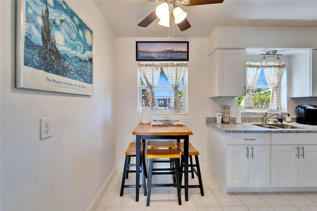 dining area with baseboards and a ceiling fan