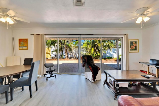 interior space with light wood-style floors, visible vents, and a healthy amount of sunlight