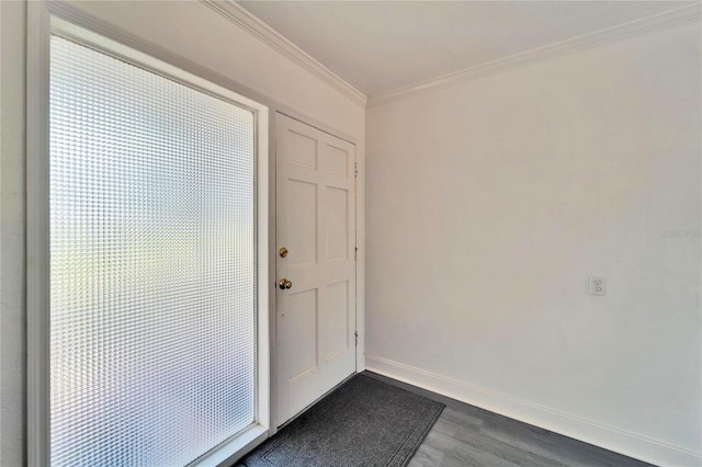 interior space with baseboards, dark wood finished floors, and crown molding