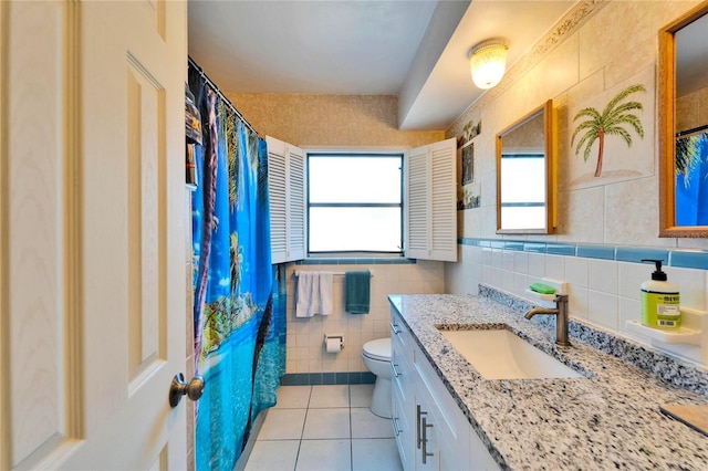 full bathroom featuring toilet, tile patterned flooring, tile walls, and vanity