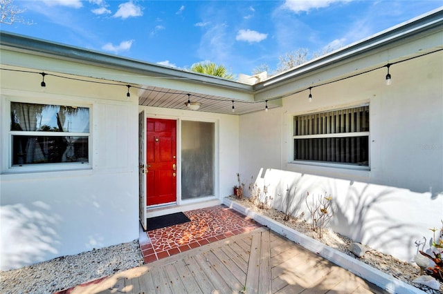 property entrance featuring stucco siding