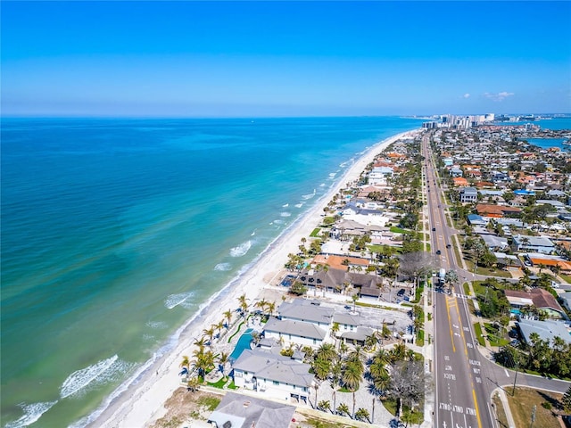 drone / aerial view featuring a residential view, a water view, and a beach view