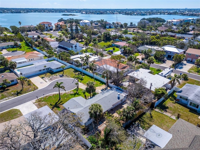 birds eye view of property with a water view and a residential view