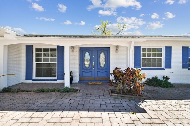 entrance to property with brick siding