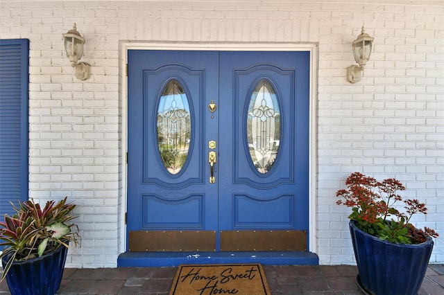 property entrance featuring brick siding