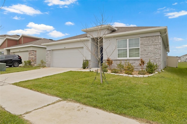 view of front of home featuring stone siding, concrete driveway, an attached garage, and a front yard