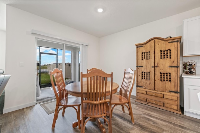 dining space with light wood-style floors and baseboards