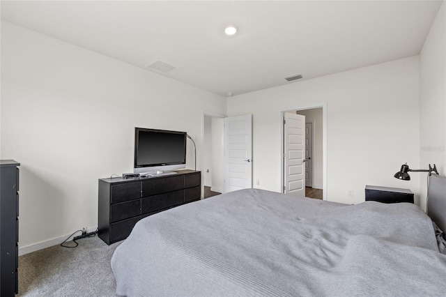 carpeted bedroom with visible vents and baseboards