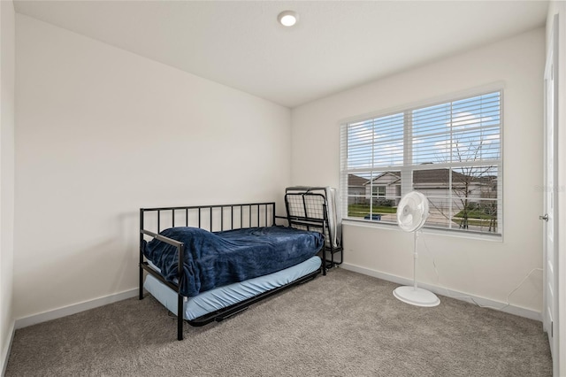 bedroom featuring carpet floors and baseboards