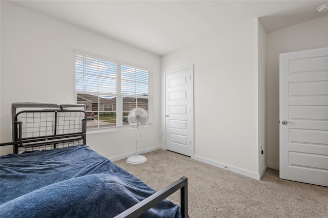 bedroom with carpet and baseboards