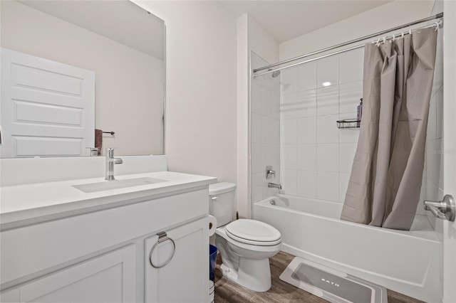 bathroom with toilet, vanity, shower / tub combo with curtain, and wood finished floors