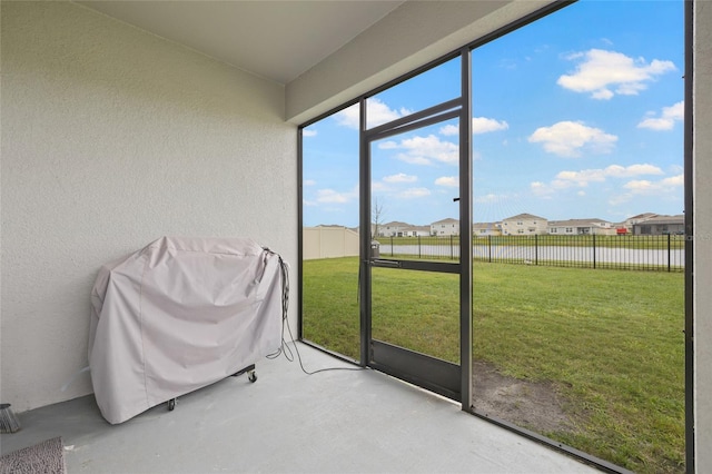 sunroom featuring a residential view