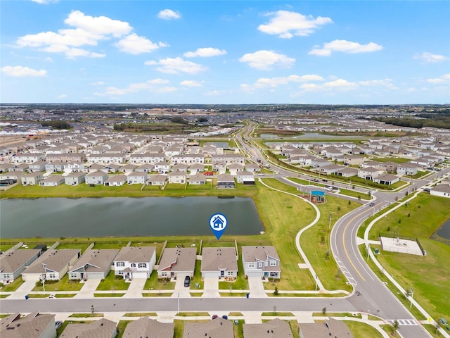 birds eye view of property with a water view and a residential view