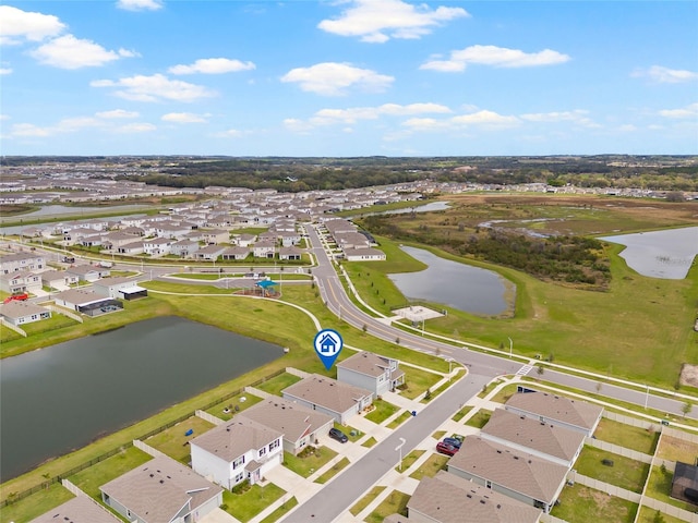 birds eye view of property with a water view and a residential view