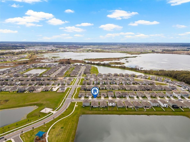 drone / aerial view featuring a water view and a residential view