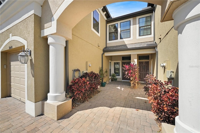 doorway to property featuring stucco siding