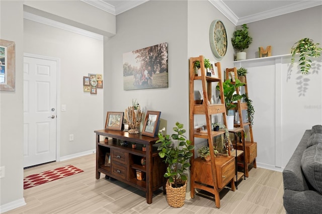 living area with crown molding, baseboards, and light wood finished floors