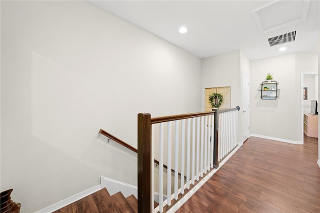 stairs featuring visible vents, wood finished floors, recessed lighting, baseboards, and attic access