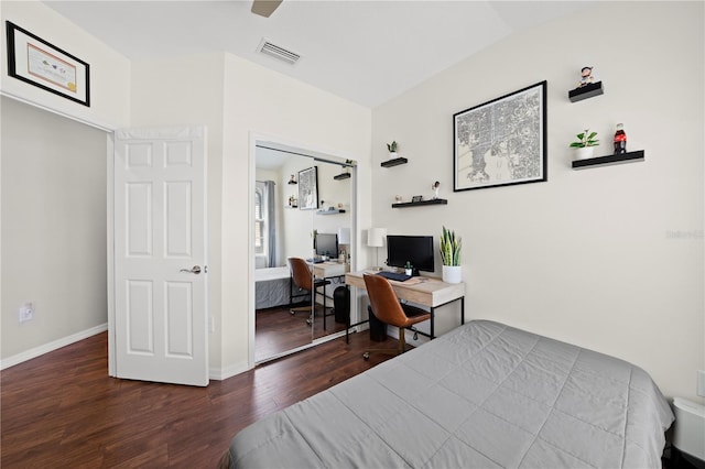 bedroom with a ceiling fan, wood finished floors, visible vents, baseboards, and vaulted ceiling