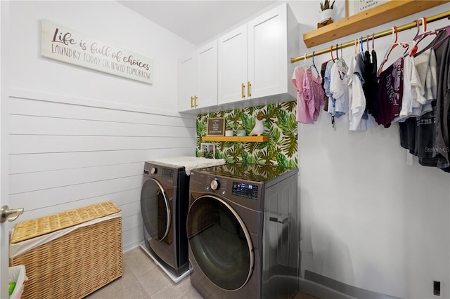 laundry room with washing machine and dryer, cabinet space, and baseboards