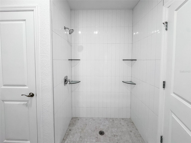 bathroom with tiled shower