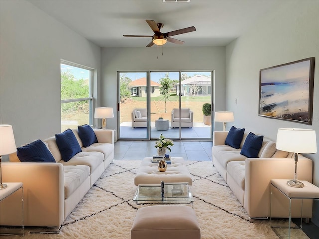 tiled living room featuring visible vents and a ceiling fan