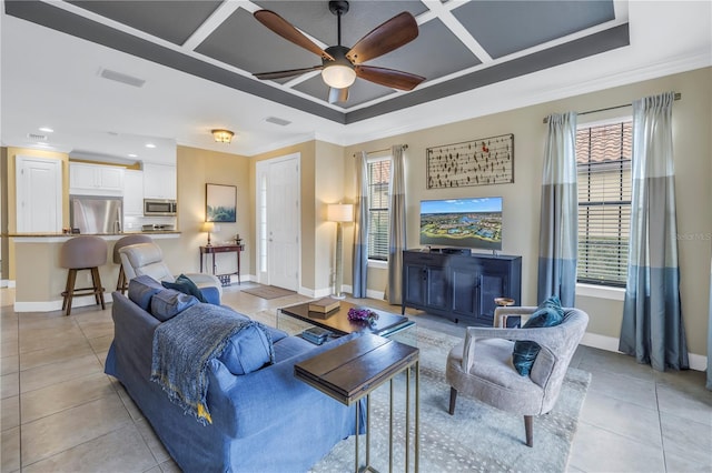 10446 Highland Park Pl, Palmetto, FL 34221 - living room featuring baseboards, crown molding, a ceiling fan, light tile patterned floors, and a raised ceiling