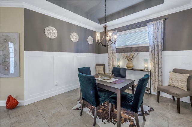 10446 Highland Park Pl, Palmetto, FL 34221 - dining room featuring a chandelier, light tile patterned floors, crown molding, a decorative wall, and a raised ceiling