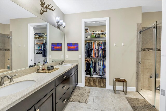 10446 Highland Park Pl, Palmetto, FL 34221 - full bath featuring a stall shower, tile patterned flooring, a spacious closet, double vanity, and baseboards