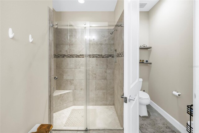 10446 Highland Park Pl, Palmetto, FL 34221 - bathroom featuring a shower stall, toilet, and baseboards