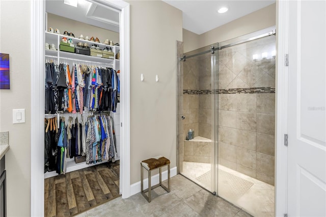 10446 Highland Park Pl, Palmetto, FL 34221 - bathroom featuring a walk in closet, a stall shower, vanity, baseboards, and recessed lighting
