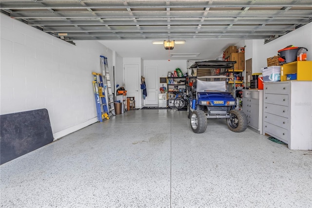 10446 Highland Park Pl, Palmetto, FL 34221 - garage featuring a garage door opener and concrete block wall
