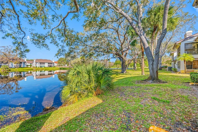 view of yard with a residential view and a water view